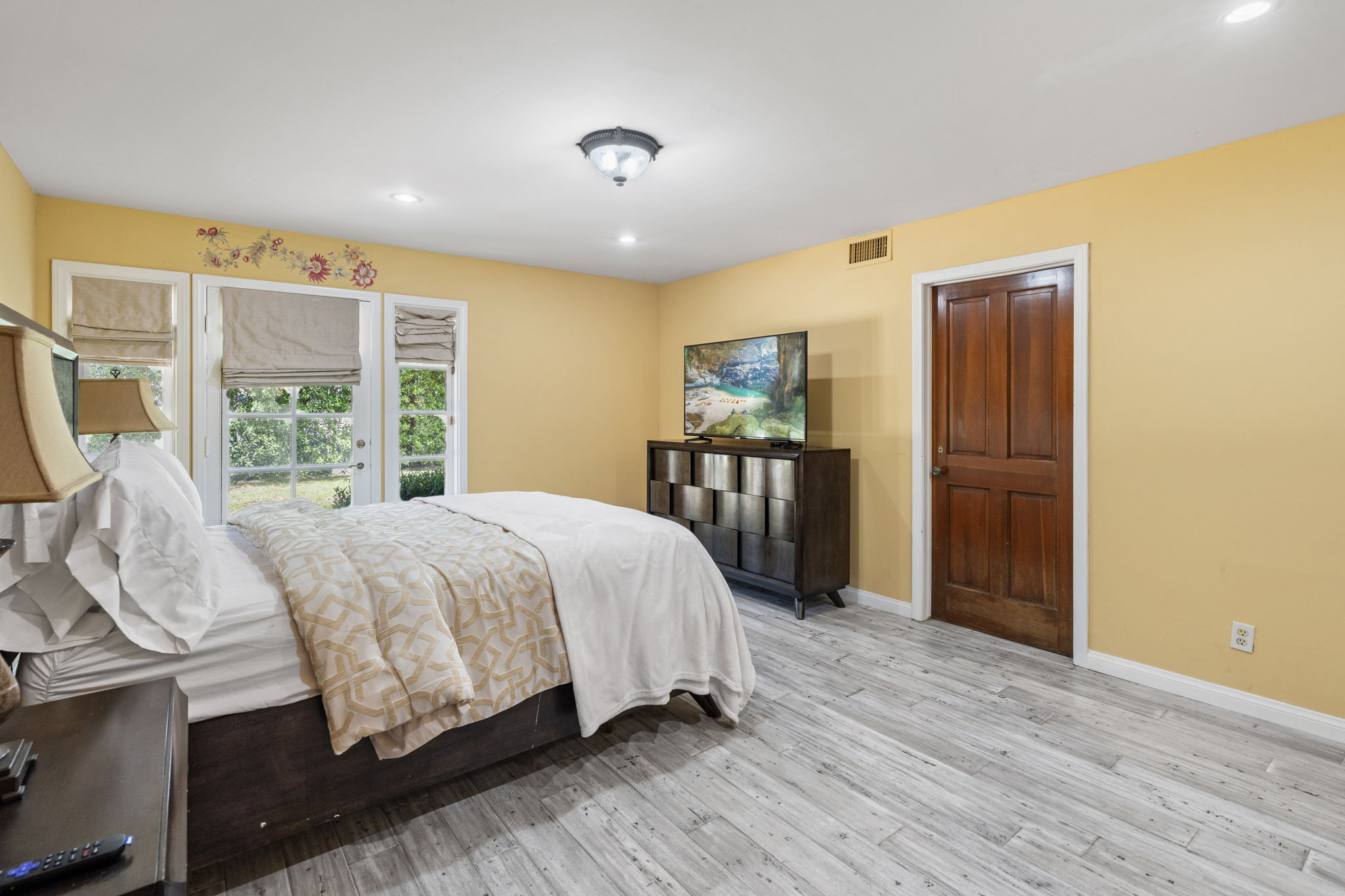 Bedroom with garden views and warm natural light