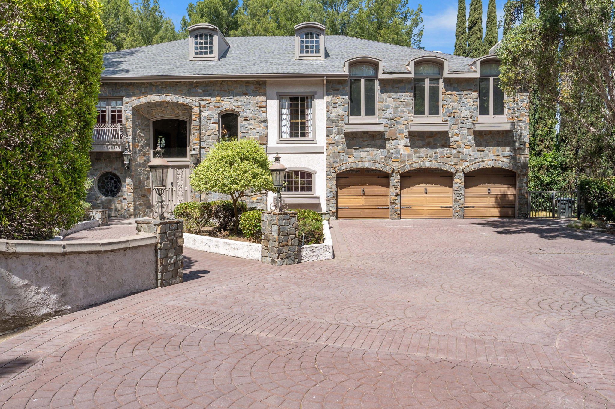 Front approach showing garages and stone exterior of Chelsea Manor