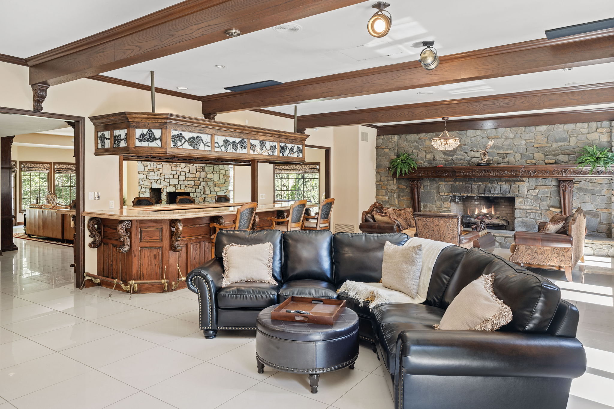 Game room with bar and fireplace for recreational relaxation