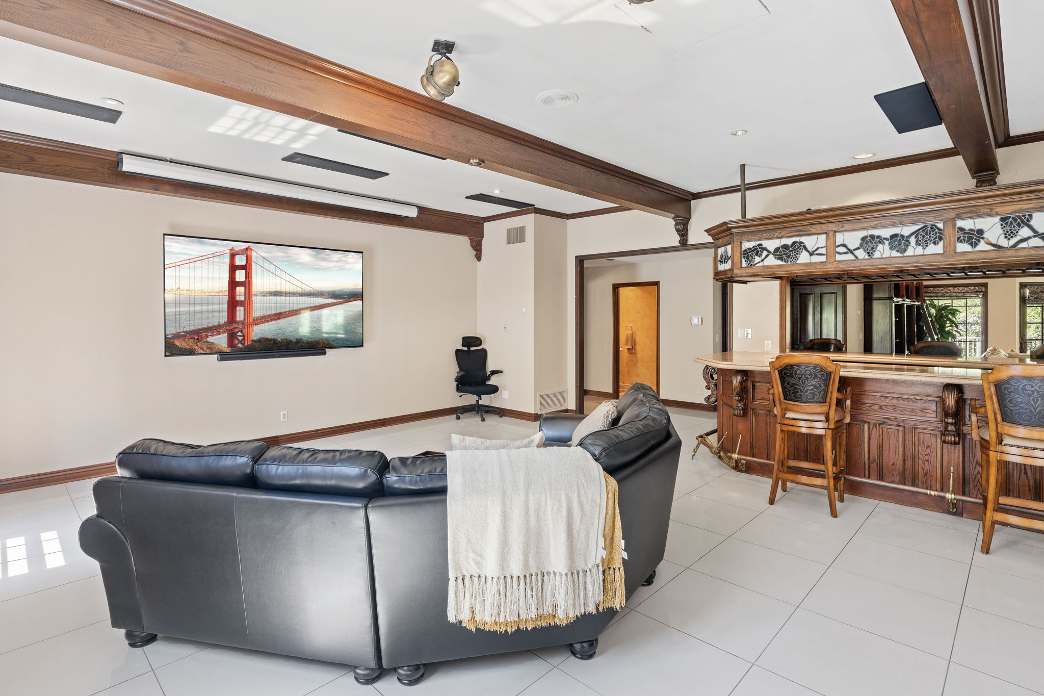Media lounge with television and bar area