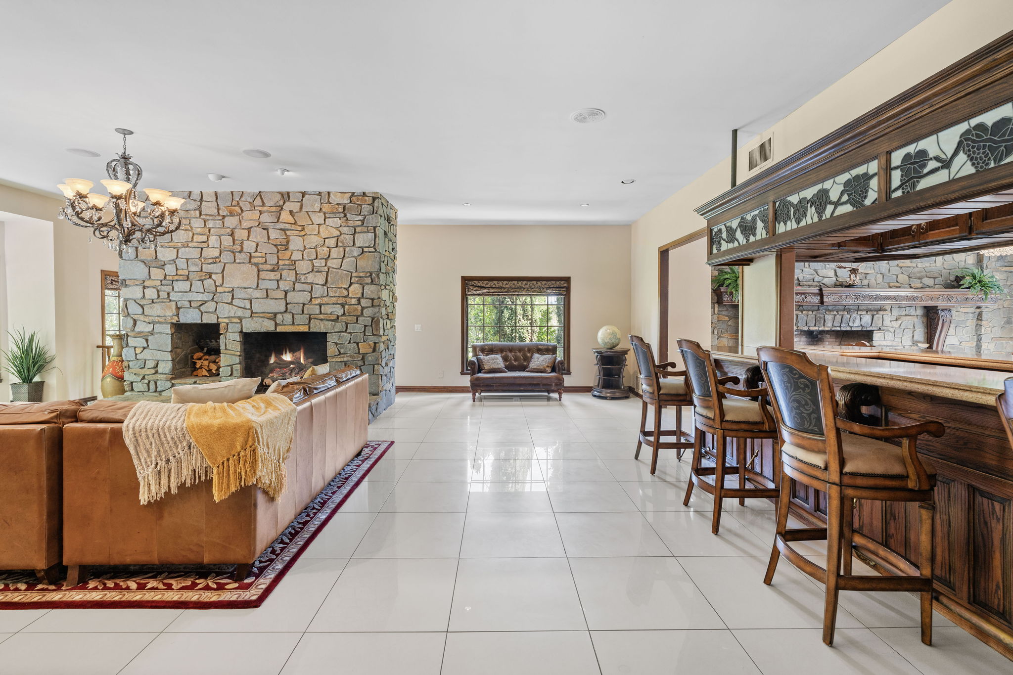 Great room featuring a stone bar and open entertaining space