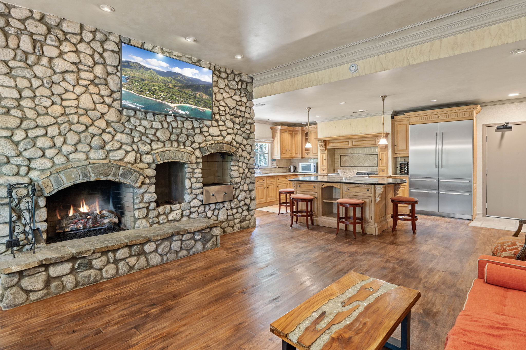 Kitchen with a stone fireplace creating a warm, home-like atmosphere