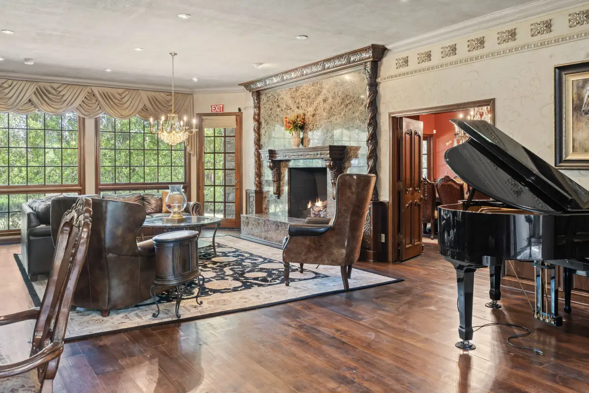 Grand lounge with piano and stone fireplace