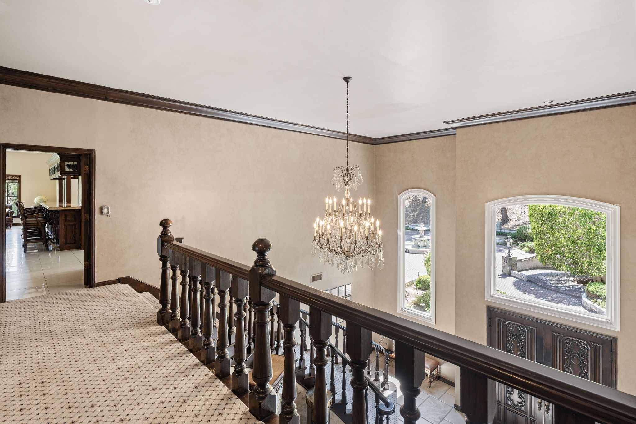 Upper landing with a framed view of the estate fountain below
